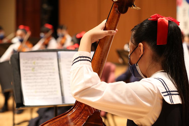 Girl Playing Cello In Orchestra