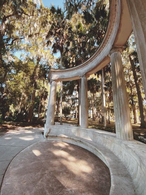 Free Curved stone columns amidst greenery in a tranquil park. Stock Photo
