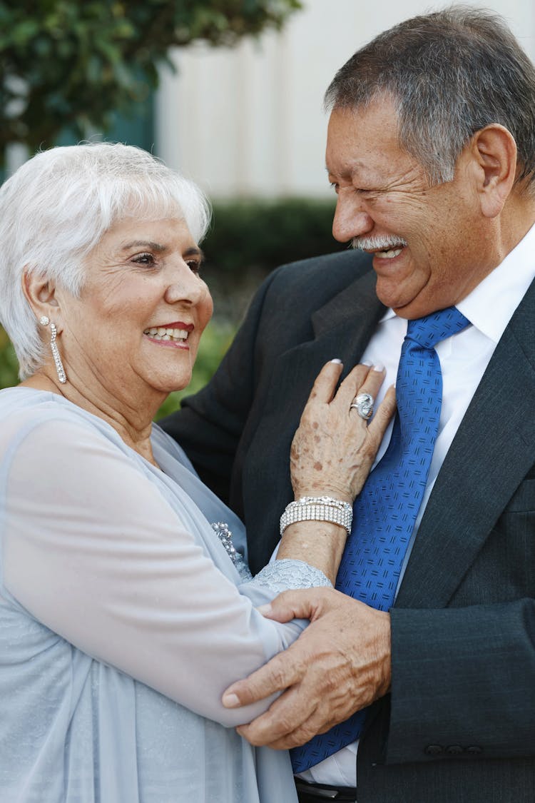 Elderly Couple Wearing Elegant Outfits Laughing Together