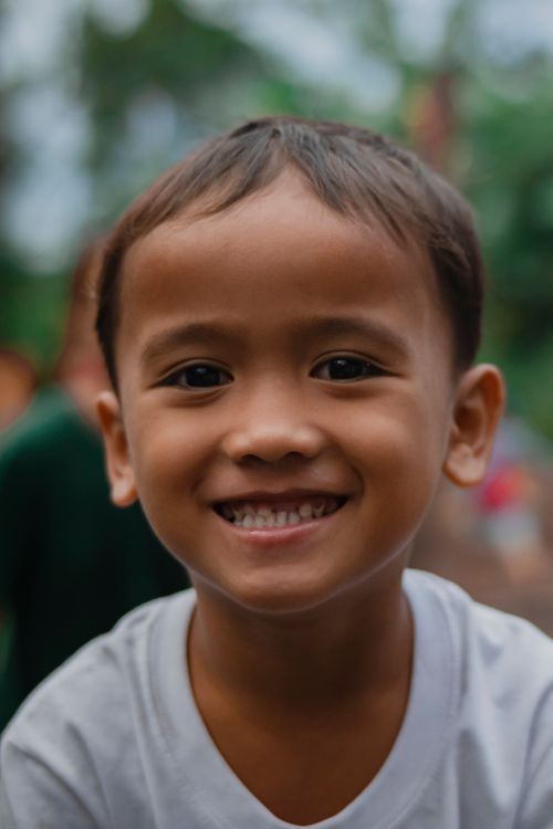 Free Cheerful young boy smiling outdoors, radiating happiness. Stock Photo