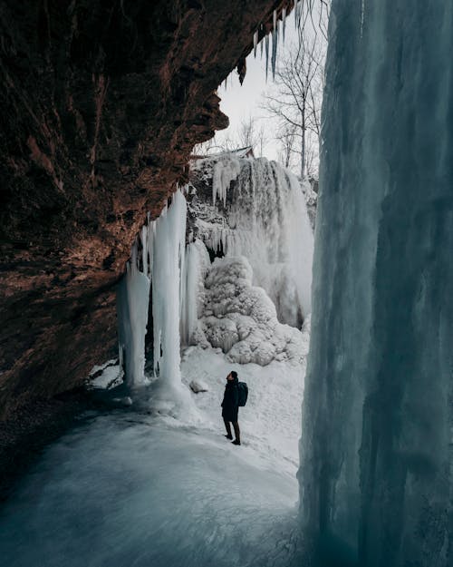 Man Standing near Rock and Ice