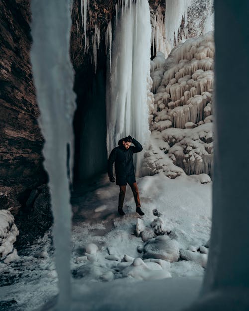 Man Standing around Ice and Snow