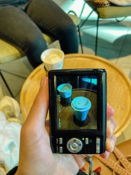 Close-up of a digital camera displaying a coffee cup on a table, capturing everyday moments.