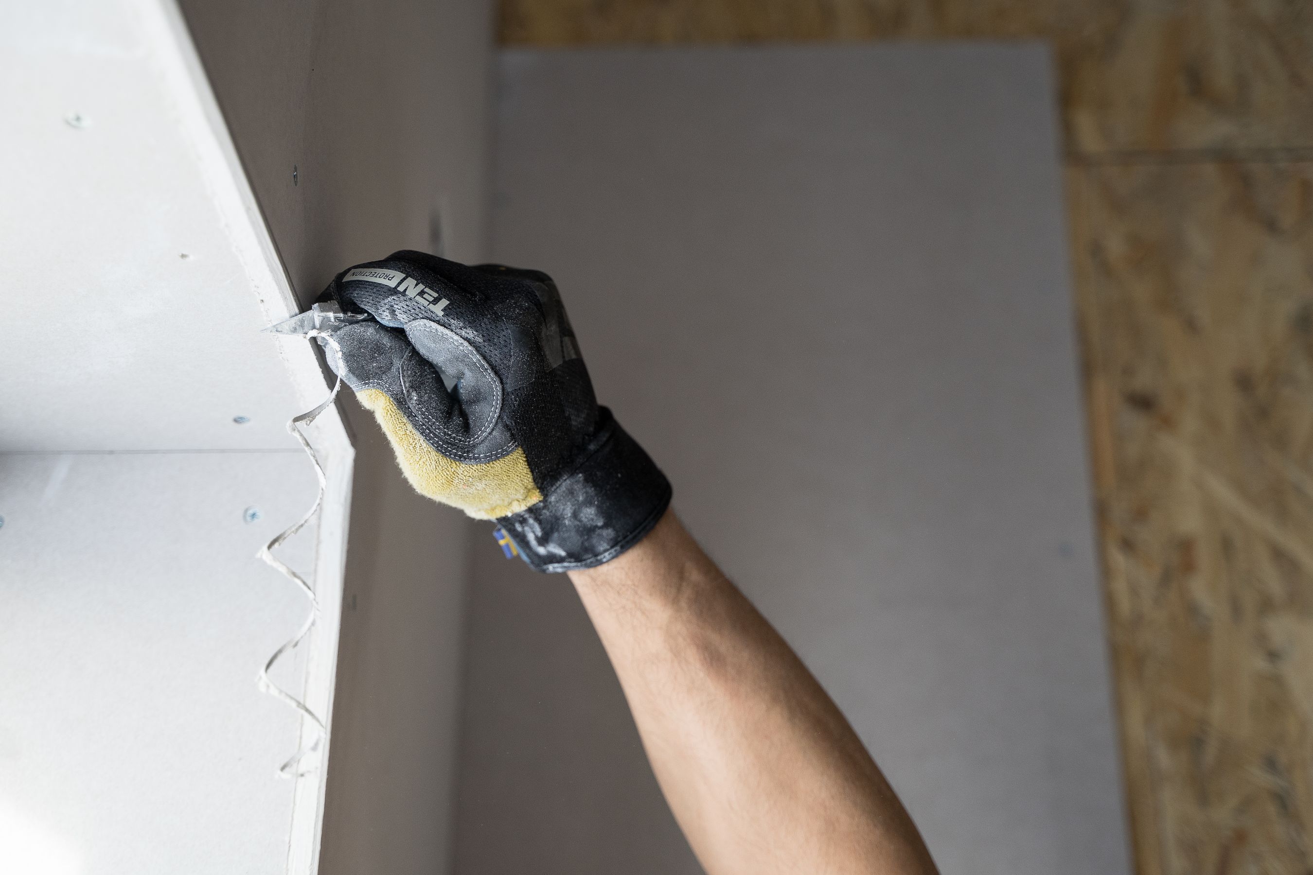 Hand troweling plaster on wall