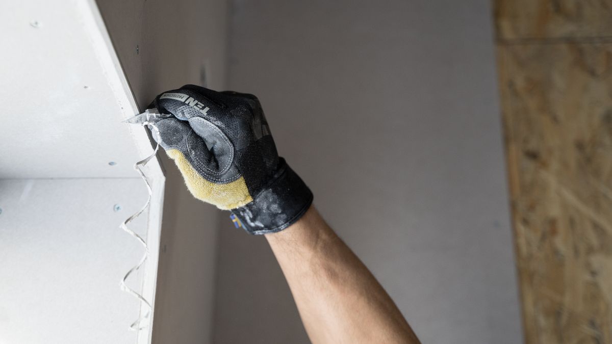 Applying joint compound over taped seams. Plan on three coats: tape, fill and finish.
