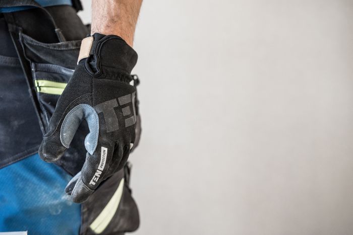 Assembly — Close-up of protective work gloves for mechanical risks
