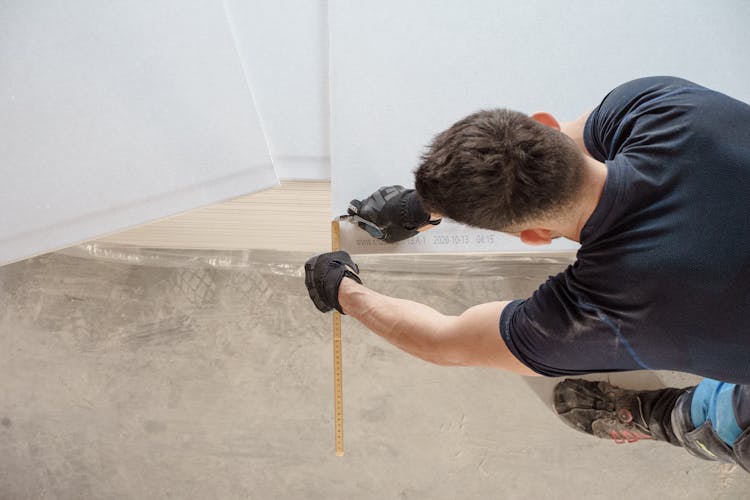 Man Cutting Plywood On Floor