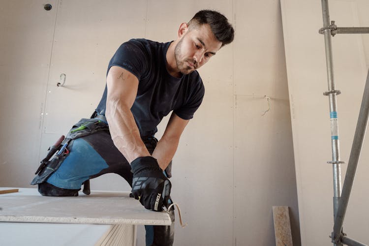 Man Cutting A Plasterboard