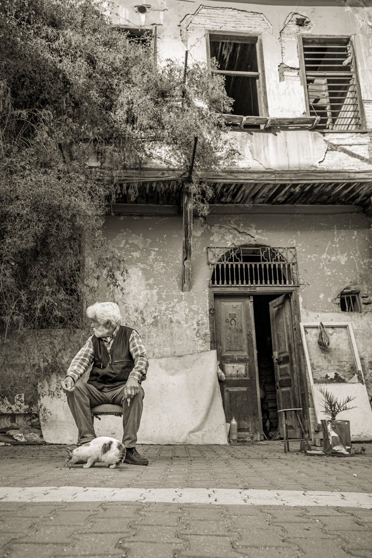 Elderly Man Sitting With Cat 