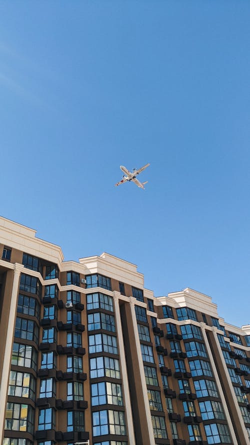 Airplane Flying over Building