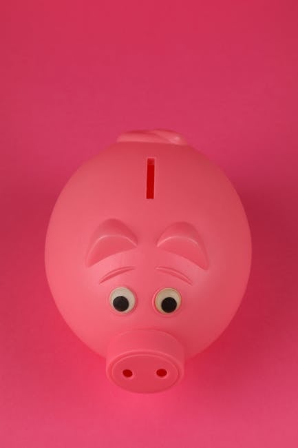 Photo by Ann H Close-up photo of a pink piggy bank on a vibrant pink background, symbolizing savings and finance.