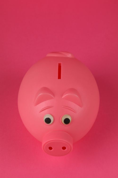 Free Close-up photo of a pink piggy bank on a vibrant pink background, symbolizing savings and finance. Stock Photo