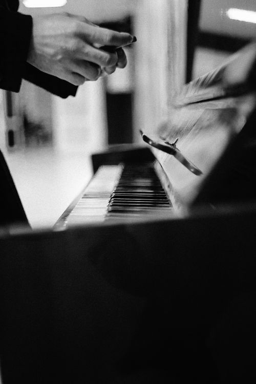 Free Evocative black and white close-up of hands above a piano keyboard, capturing artistic expression. Stock Photo