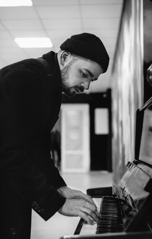 Free A monochrome image of a man playing the piano, deeply engaged in his musical performance. Stock Photo