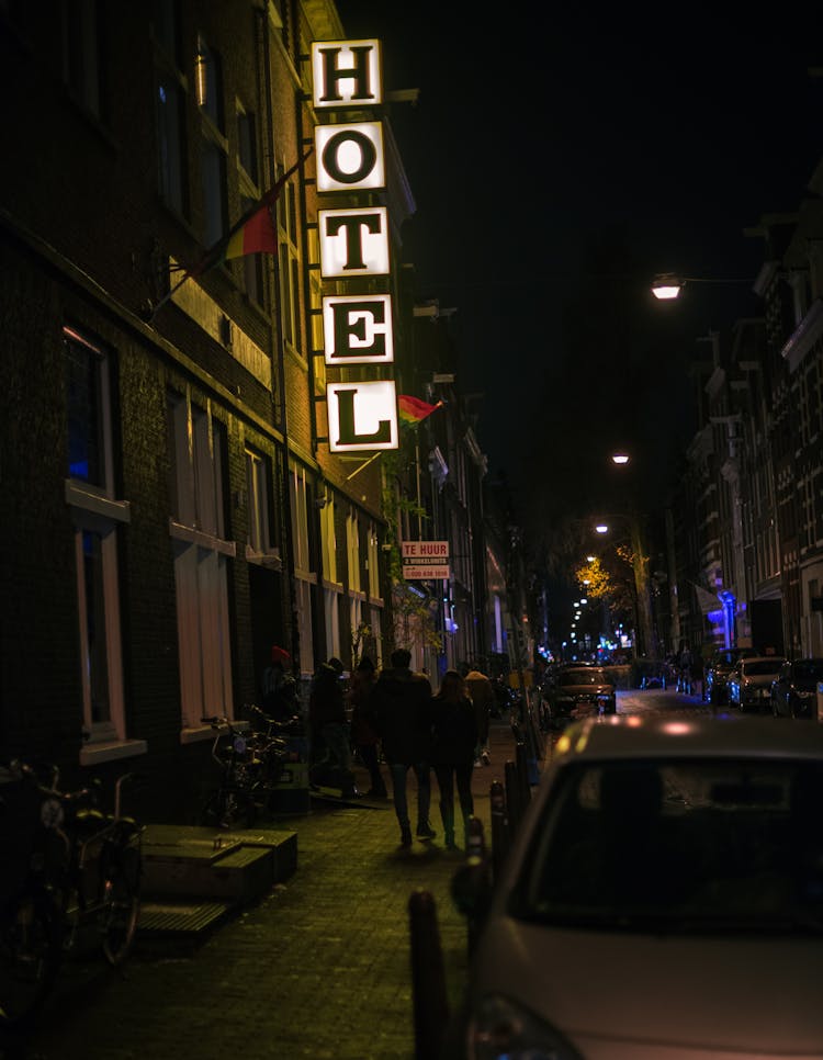 People Walking On The Street At Night