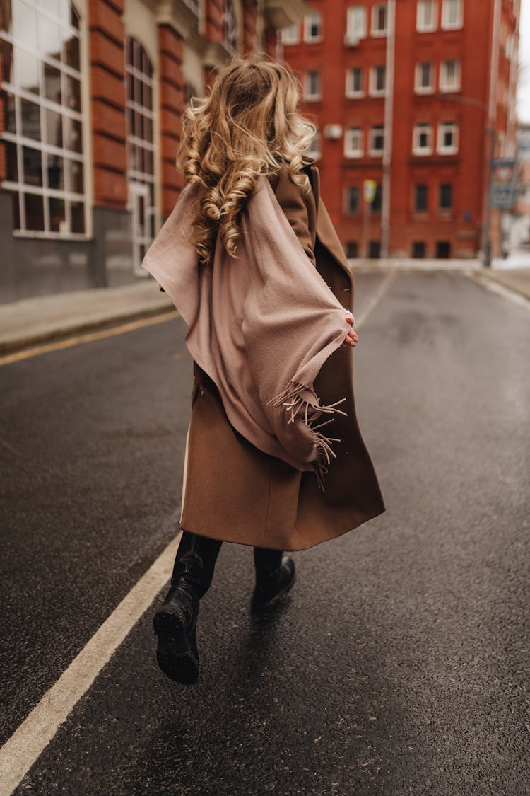 Blond Woman In Winter Coat And Warm Shawl Walking In Street 