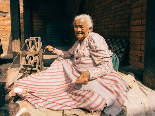 Elderly Woman using a Spinning Wheel