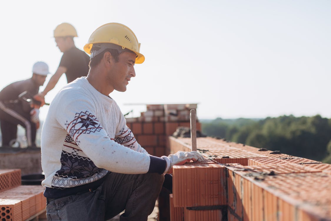 Free Brick Workers at Construction Site  Stock Photo
