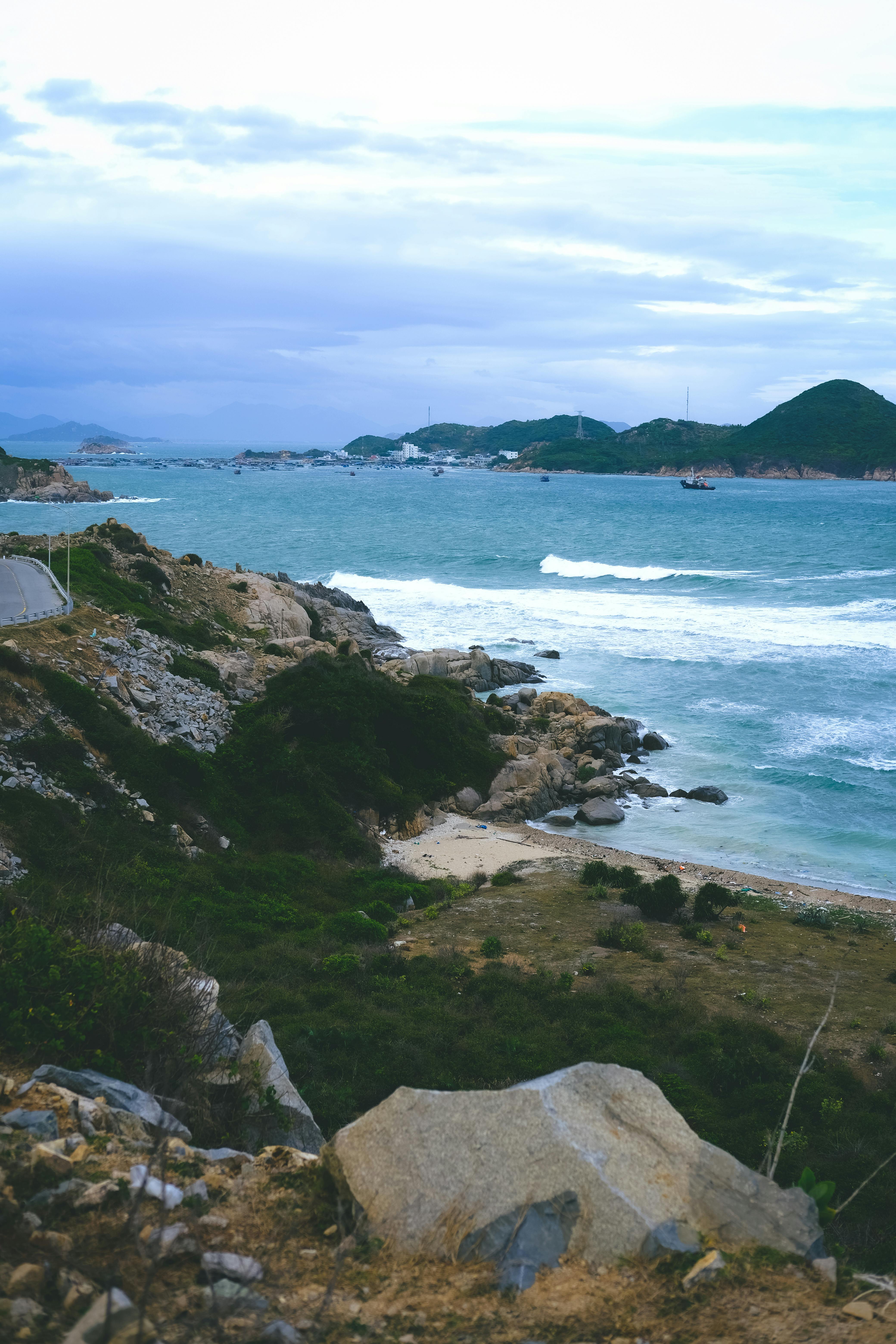Explore the rocky coastline of Ninh Thuan, Vietnam with waves crashing against the shore.