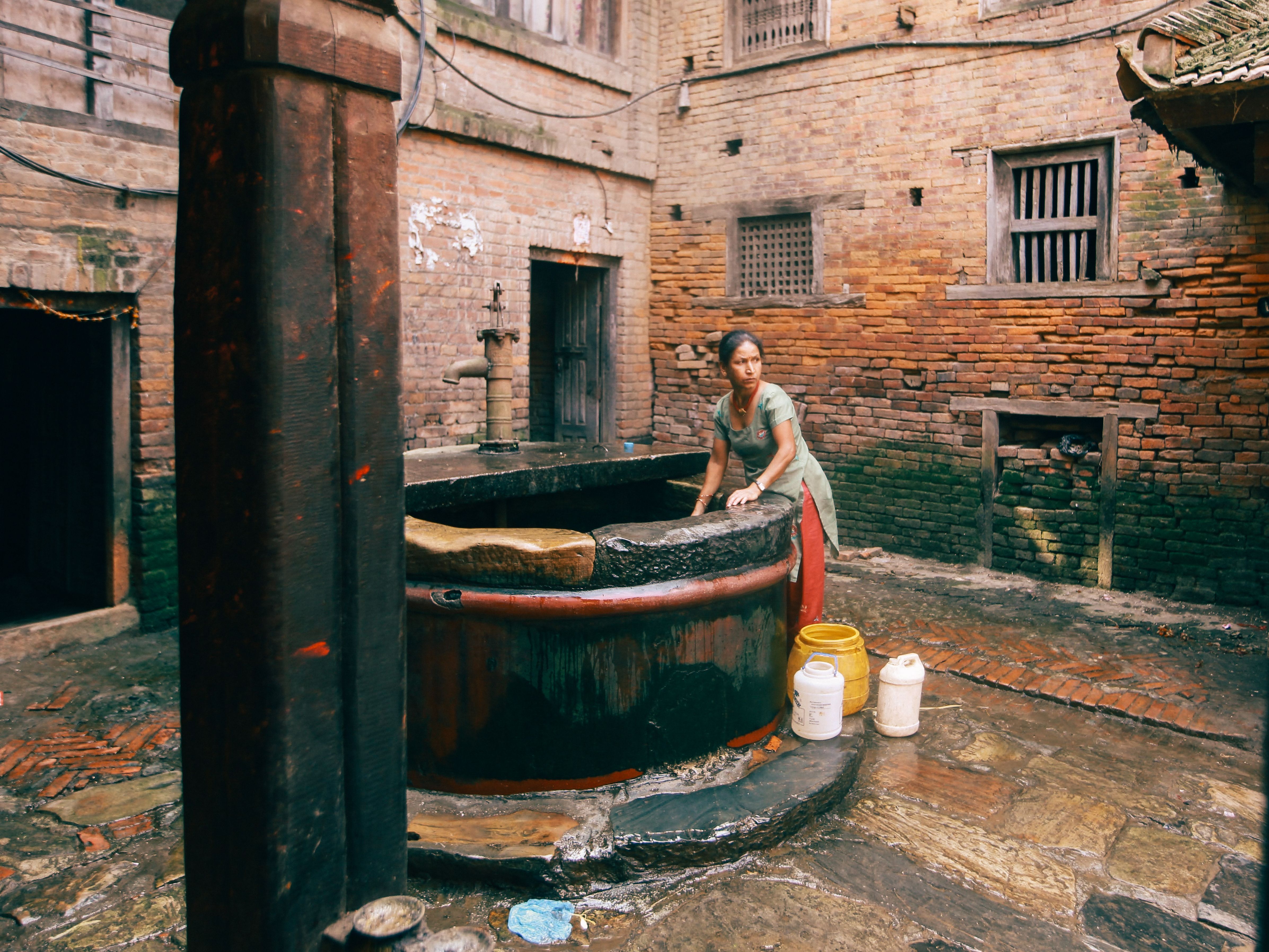 Woman Standing next to a Well · Free Stock Photo