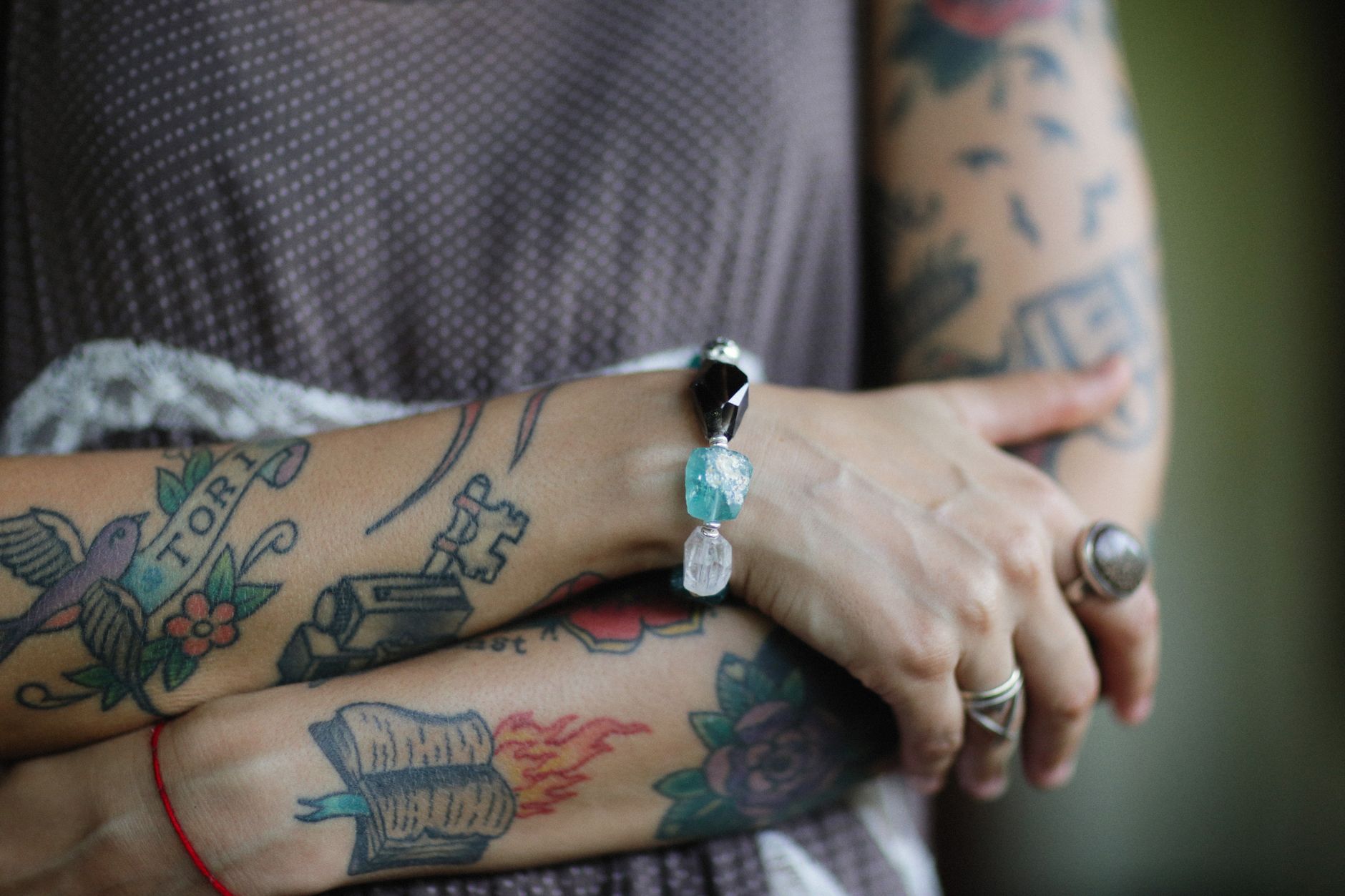 Detailed black and colored temporary tattoo designs on the hand and wrist, close-up