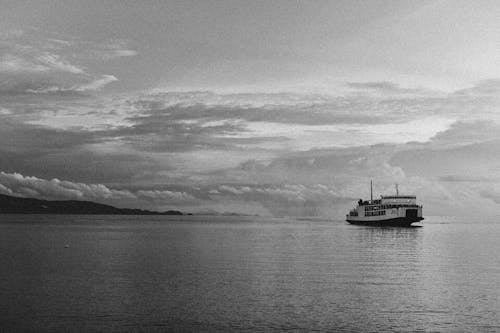 Grayscale Photo of Ship on Sea