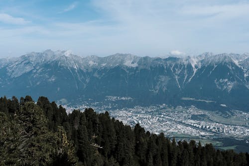 An Aerial Photography of Green Trees the Mountain Under the Cloudy Sky