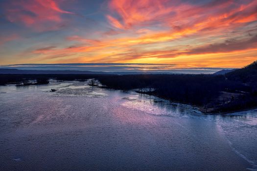 A breathtaking sunset over Reads Landing, Minnesota, showcasing vibrant colors and a serene water view.