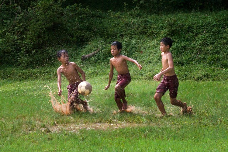 Three Boys Playing Soccer