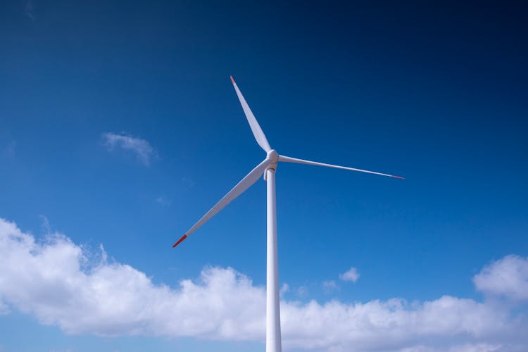 White Wind Turbine Under Blue Sky