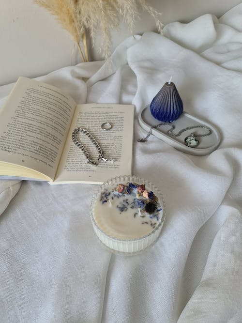 Open Book and Candles on White Fabric