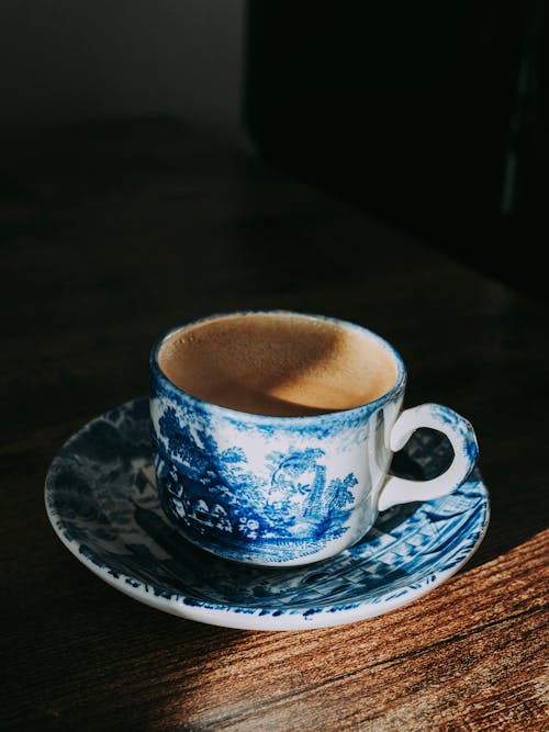 Free White and Blue Ceramic Teacup on Saucer Stock Photo