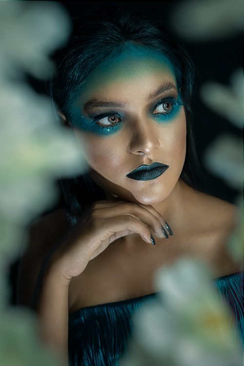 Free Close-up of a woman with artistic makeup and dark tones, Delhi. Stock Photo