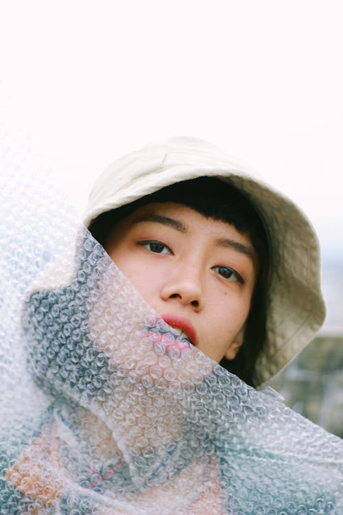Free Girl in Hat behind Bubble Wrap Stock Photo