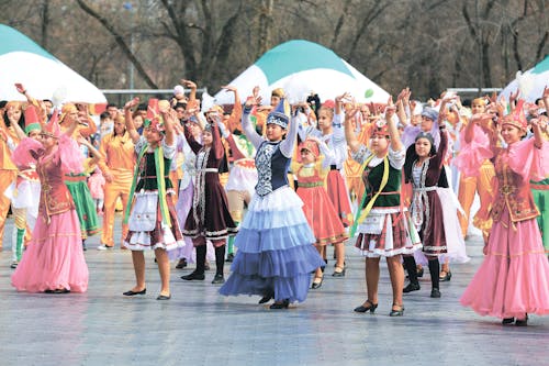 Women and Girls Wearing Traditional Dresses Holding Up Two Hands