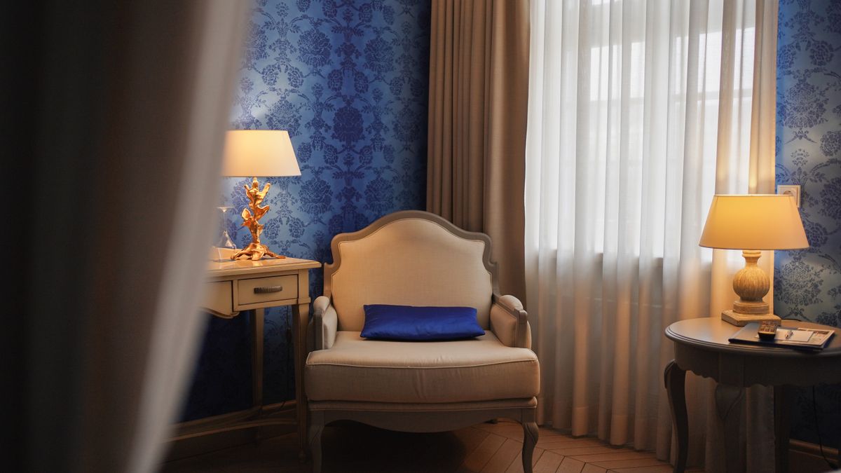 Elegant hotel room with classic furniture, soft lighting, and warm ambiance.