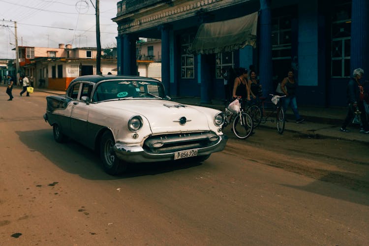 
A White Vintage Car On The Road