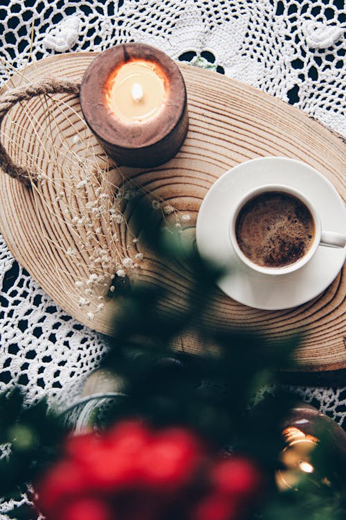 Top View of a Coffee and Candle Standing on a Wooden Tray on the Table 