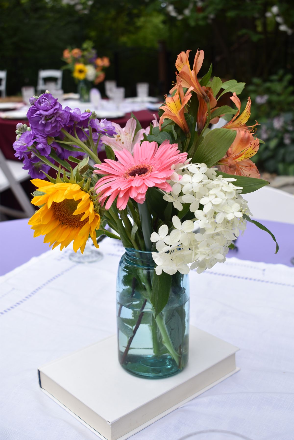 Rows of sunny mixed bouquets in kraft wrap.