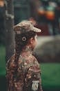 Man in Brown and Green Camouflage Jacket Wearing Gray Cap