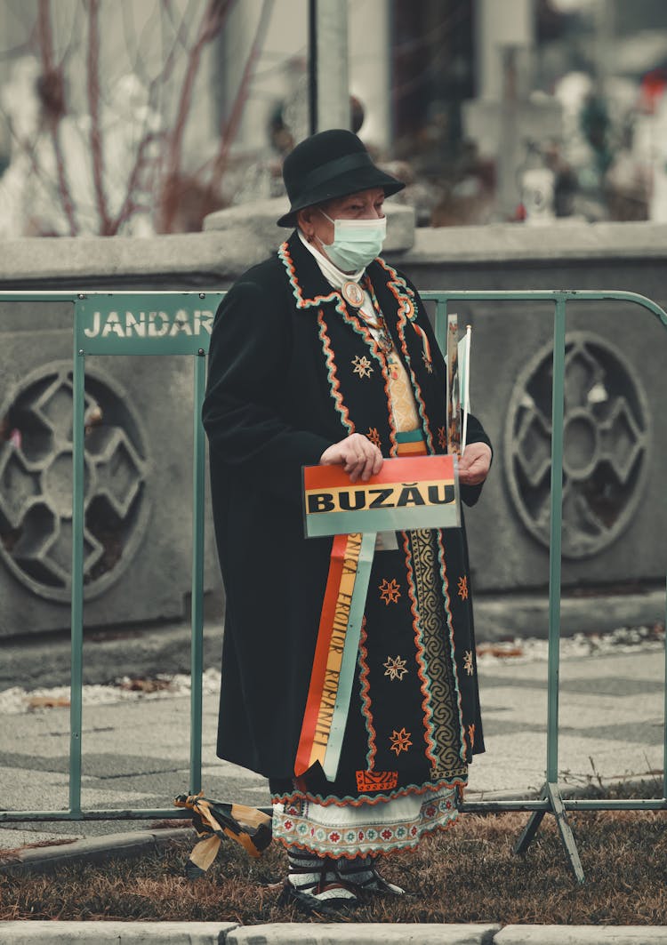 Woman In Coat Standing With Banner