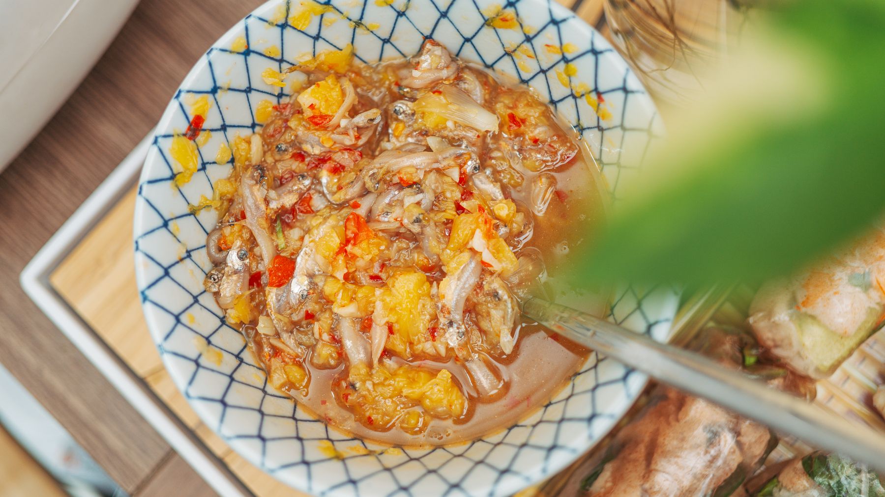 Un piatto di salsa di pesce al peperoncino servito in una ciotola di ceramica decorativa, perfetto per aggiungere sapore ai pasti.