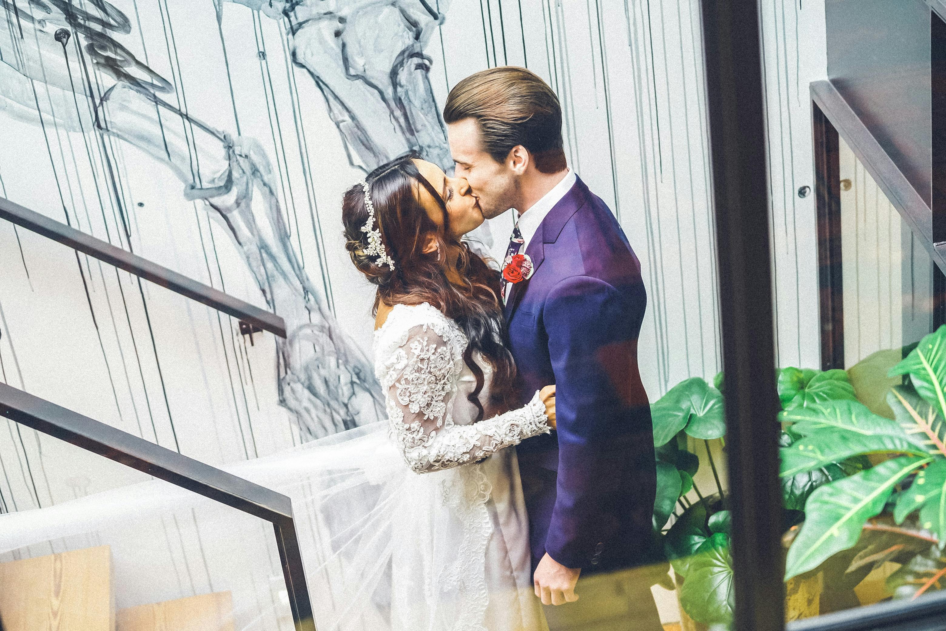 Bride and groom share a romantic kiss at an indoor wedding in Chicago.
