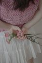Woman in White Floral Skirt Holding Pink Rose Bouquet