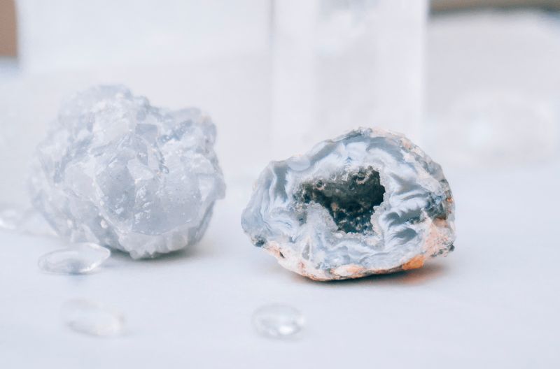 Elegant blue agate and quartz crystals on a white background, highlighting their natural textures and clarity.