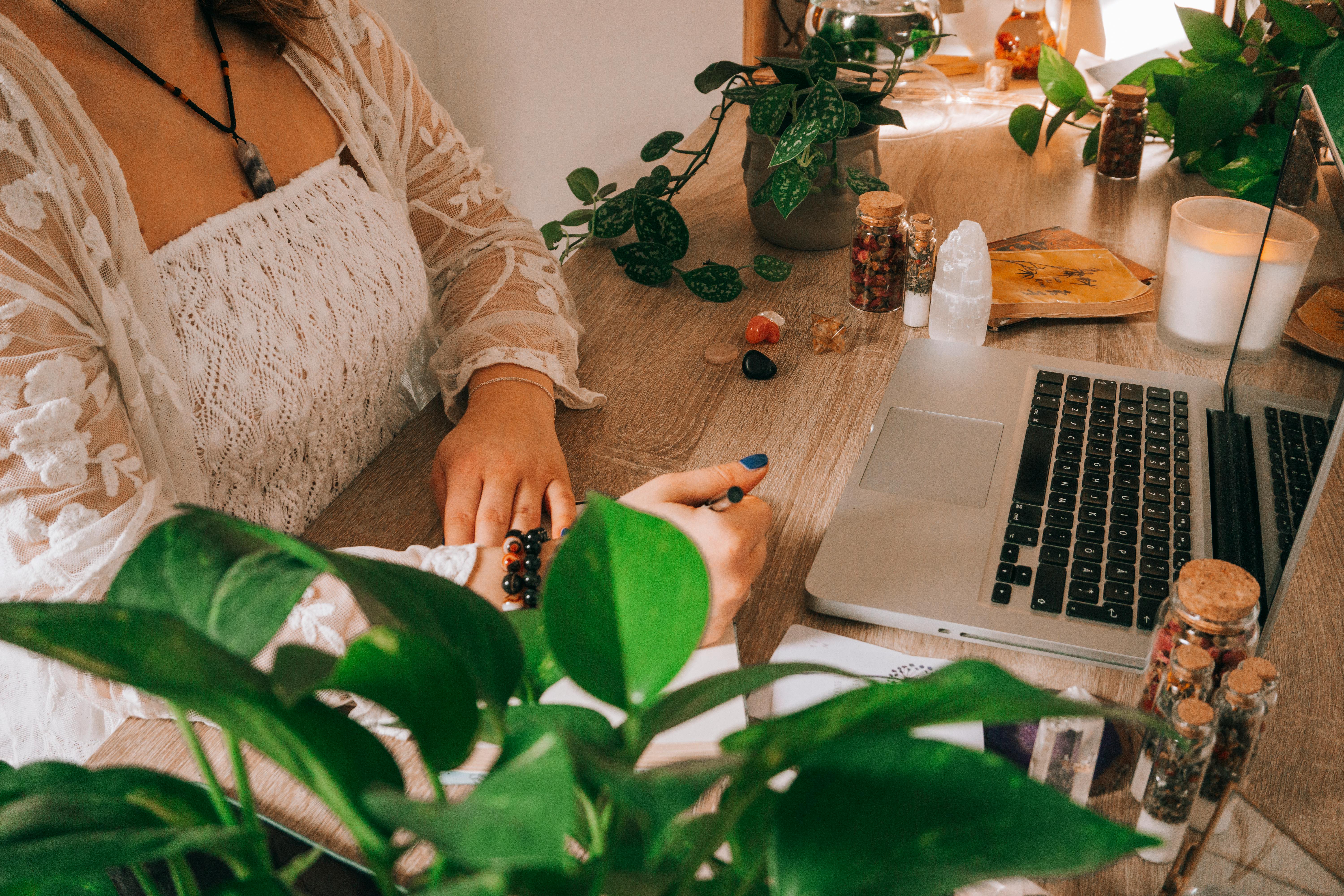 Woman Sitting Behind Desk and Writing on Paper · Free Stock Photo