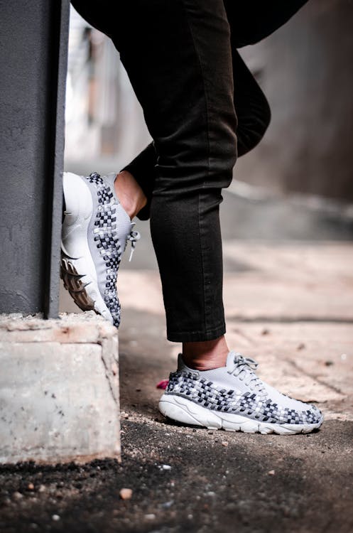 Person Wears Pair of Gray Low-top Sneakers · Free Stock Photo