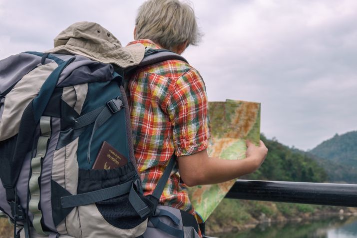 Man holding green and brown map