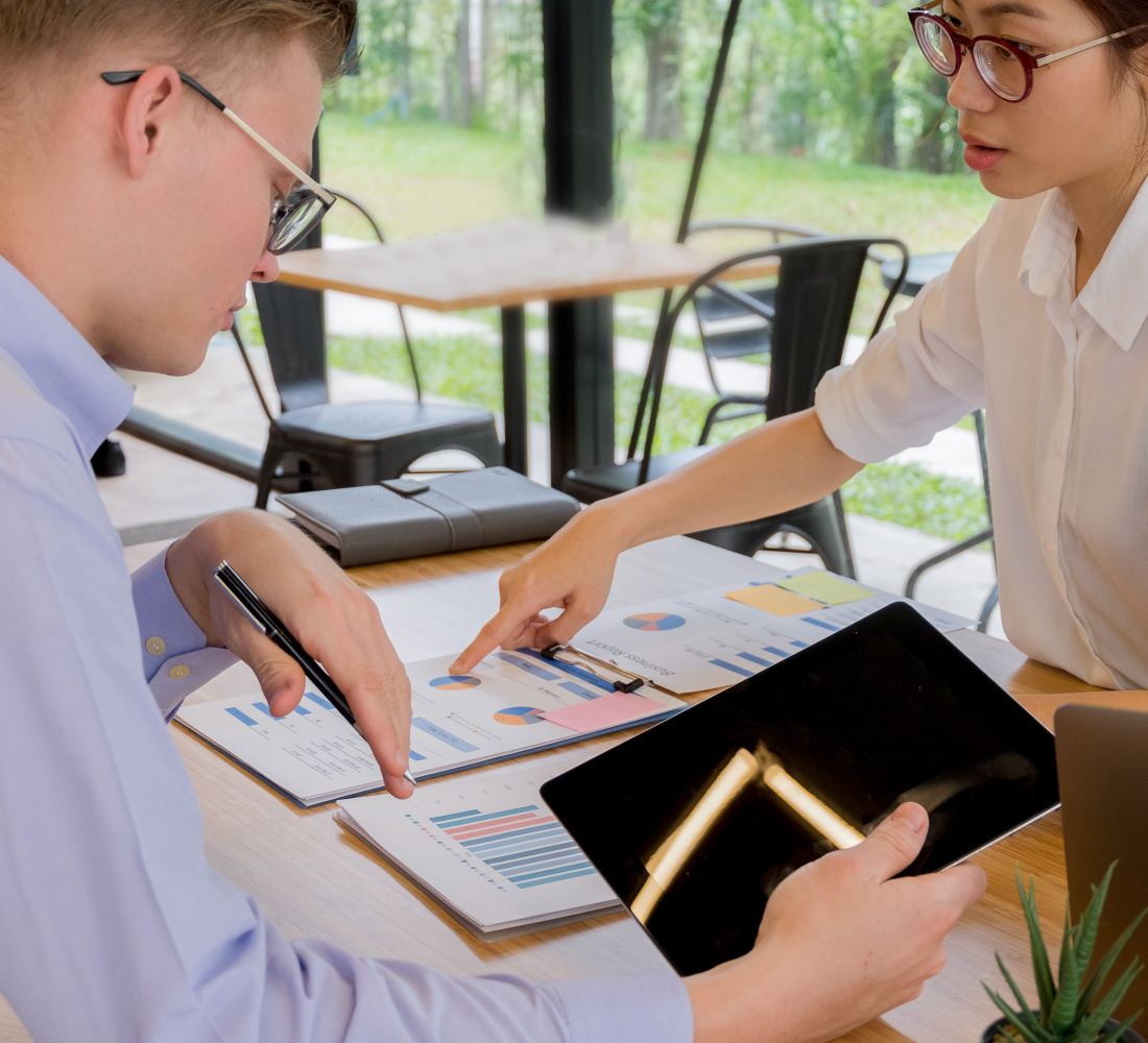 Two people reviewing performance charts at a table