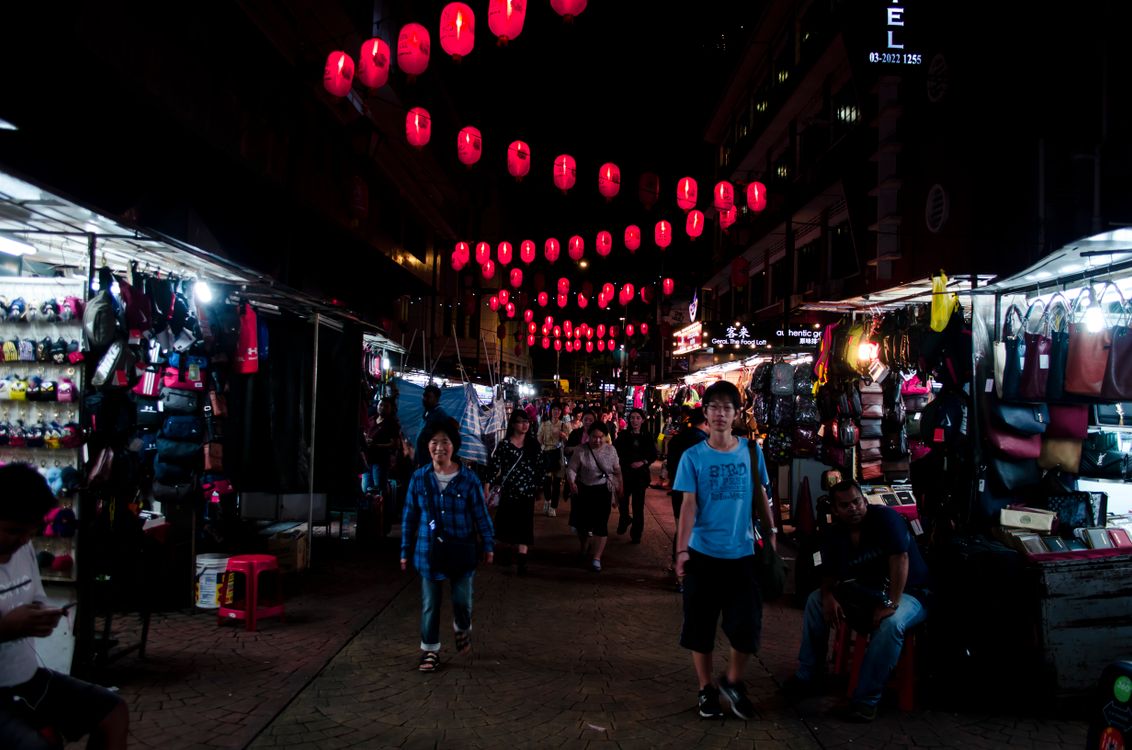 Busy night market street with Asian lanterns in Kuala Lumpur